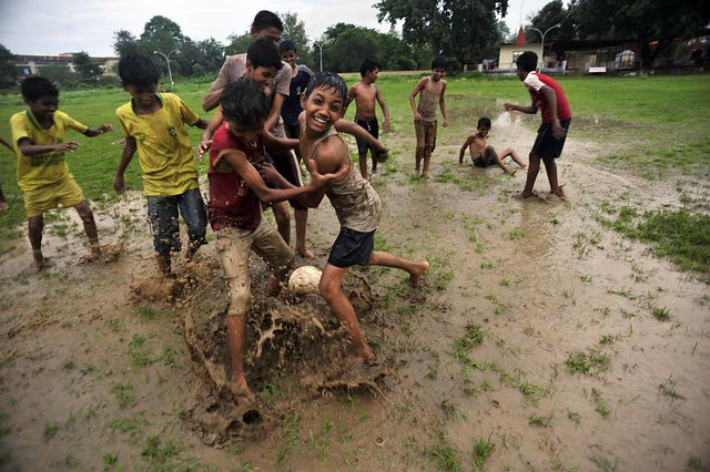 Children Playing Football In Rain