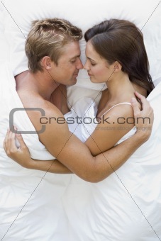 Couples Hugging In Bed